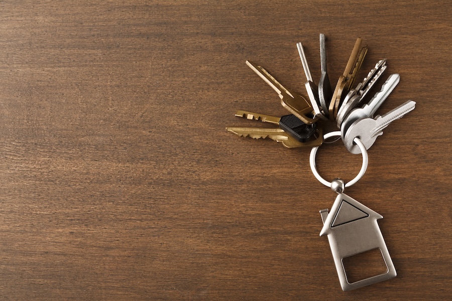 bunch of keys with house shaped keychain on white 2026 01 08 23 10 25 utc